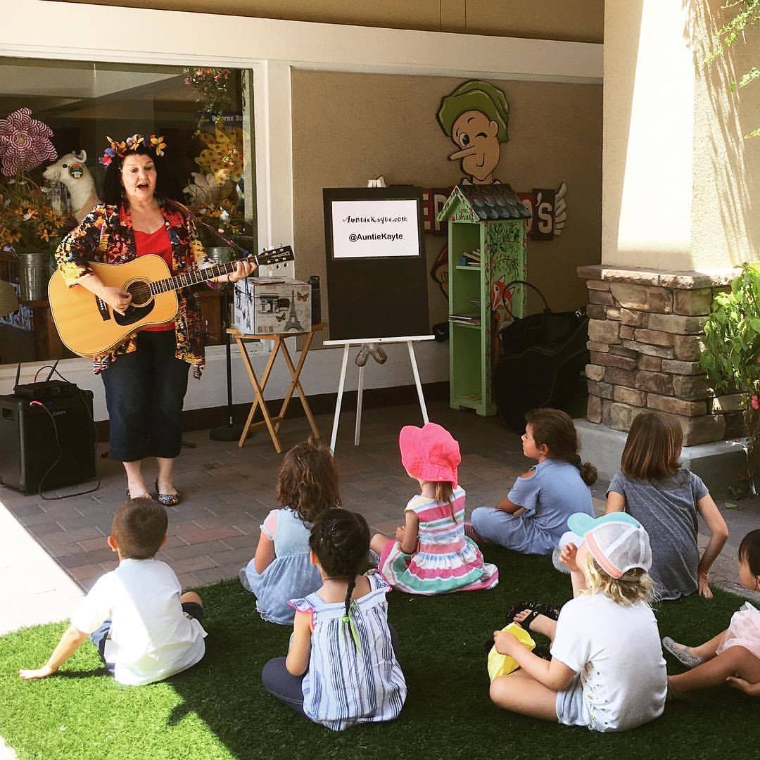 Auntie Kayte performing childrens' music at a shopping mall